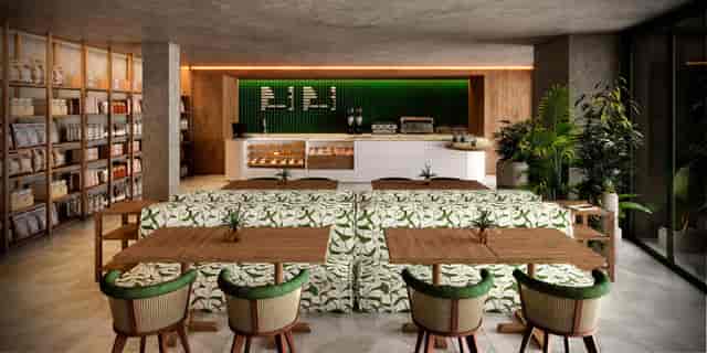 Modern café at Kimpton Tres Rios, ideal for networking events with lush greenery.