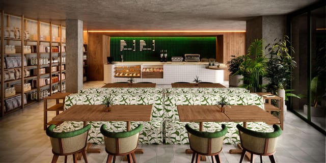 Modern café at Kimpton Tres Rios, ideal for networking events with lush greenery.