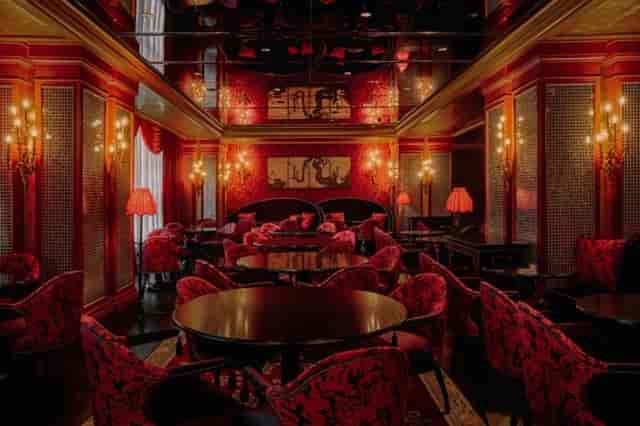 Palais de Chine at L'Escape Hotel: opulent venue with rich red decor for upscale events.