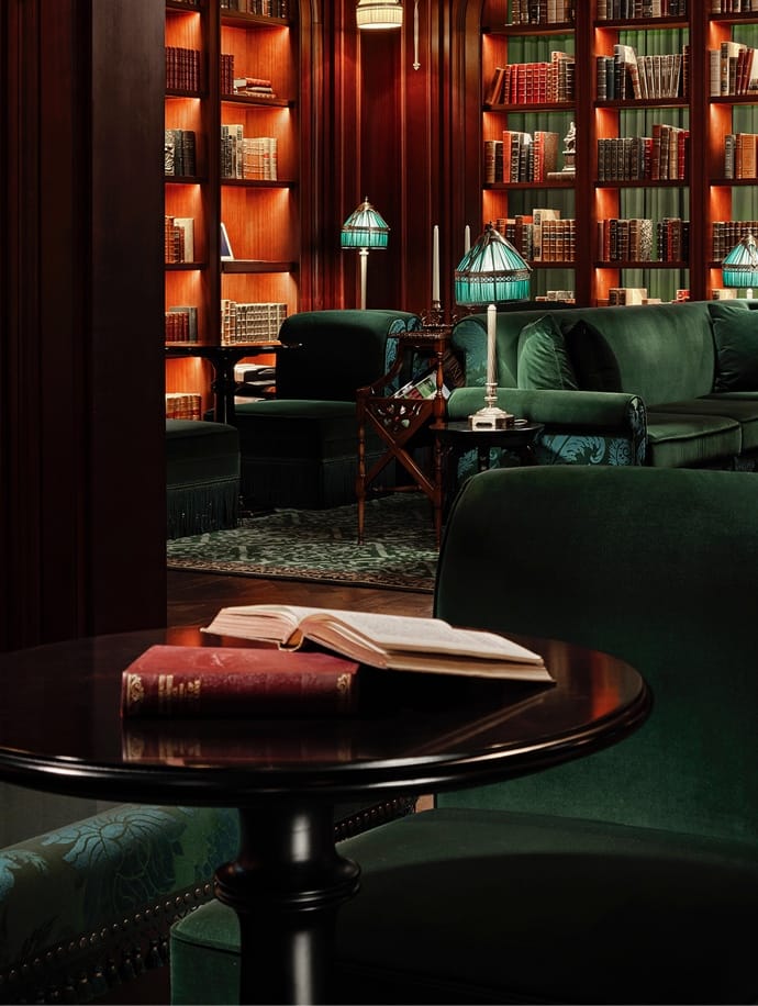 Sophisticated lounge at L'Escape Hotel with plush green seating for networking events.