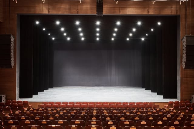 Spacious COEX auditorium with minimalist stage, ideal for events and presentations.