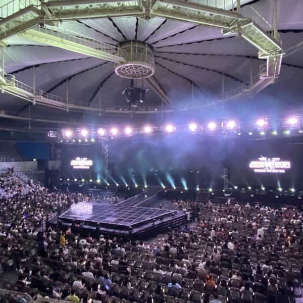 SK Handball Stadium stage set for concert, featuring dynamic lighting and spacious layout.