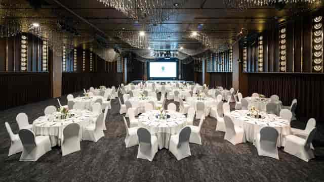 Elegant boardroom setup with round tables for conferences and gala dinners.