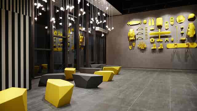 Modern event space in L7 Myeongdong with geometric seating and vibrant accents.