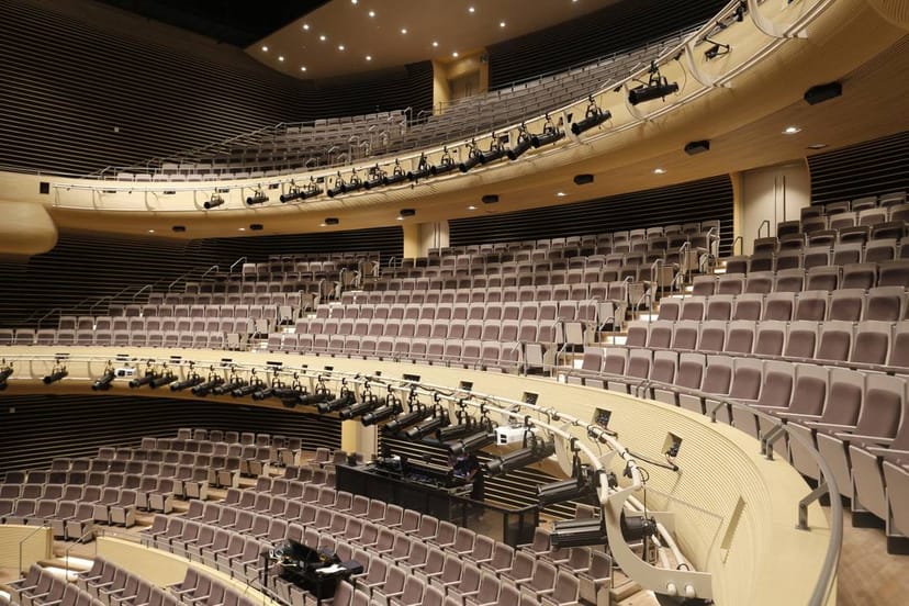 Modern auditorium with tiered seating at U+ Stage, LG Arts Center Seoul for conferences.