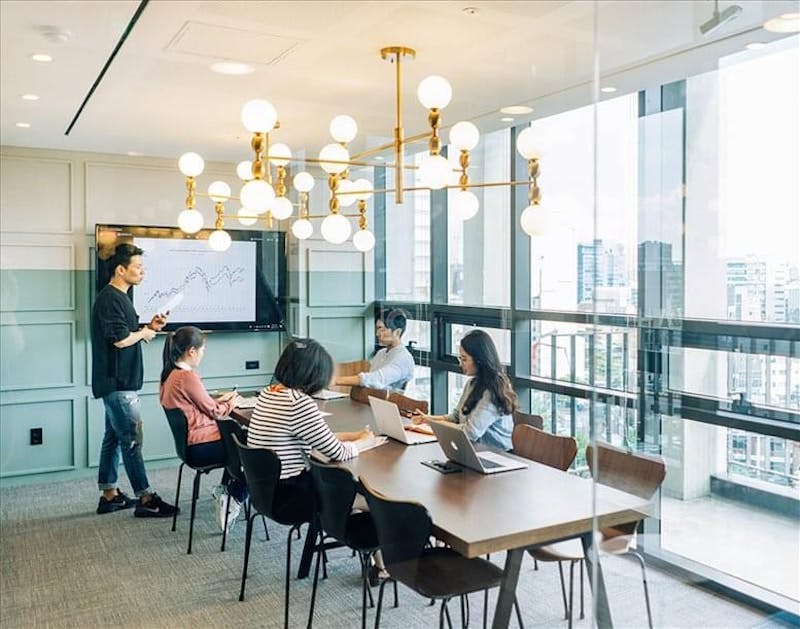 Modern seminar room with large windows, ideal for meetings and events.