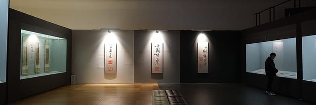 Modern exhibition hall with illuminated wall art, ideal for networking events and gatherings.