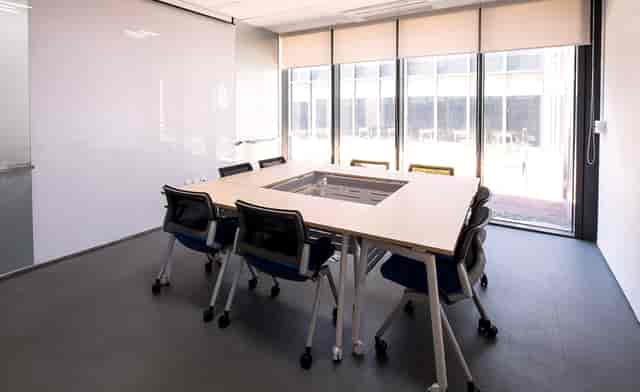 Modern conference room with large table, ideal for collaborative meetings and brainstorming.