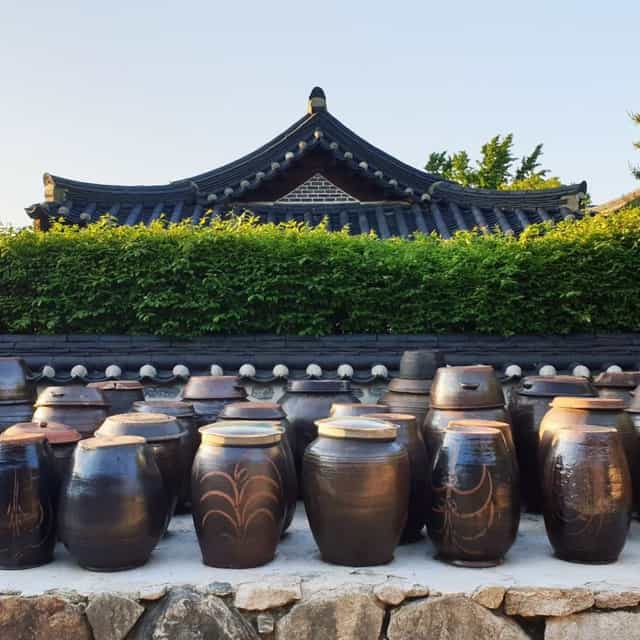 Seoul Namsan Gugakdang theater with traditional jars, ideal for outdoor events and gatherings.