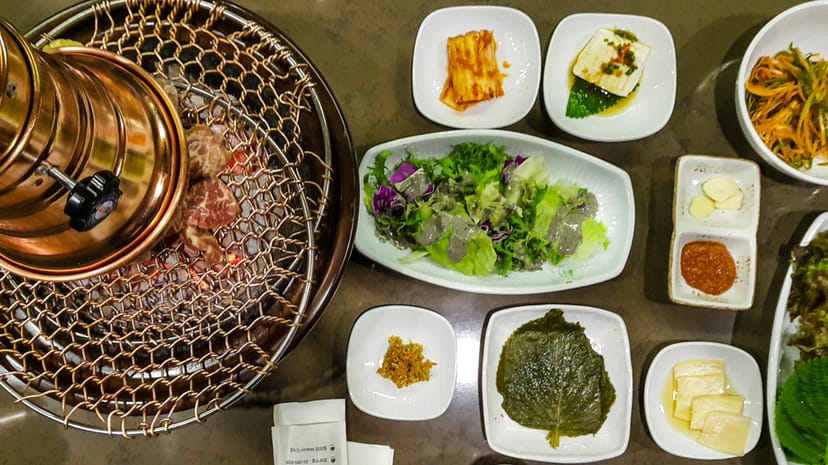 Dining table setup with grill for team-building events at Maple Tree House.