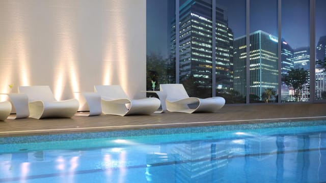 Lotte Hotel Seoul indoor pool with modern lounge chairs, ideal for upscale events.