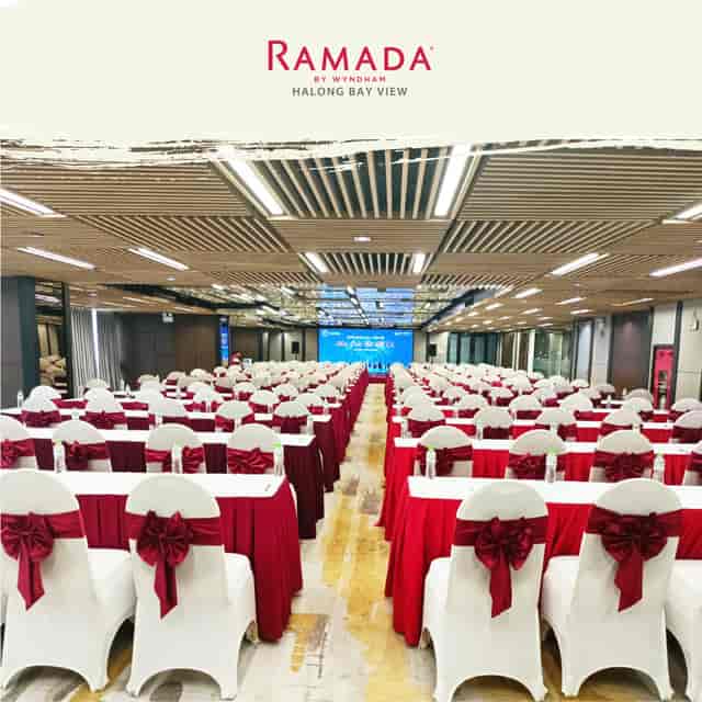 Ramada By Wyndham conference room with red tablecloths, ideal for seminars and events.