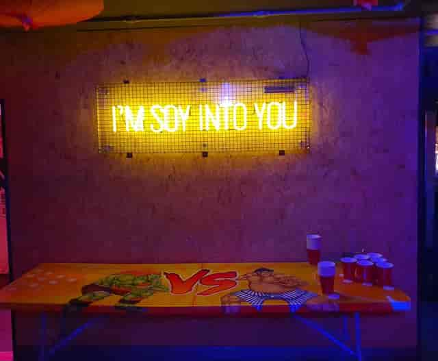 Vibrant Tokyo Joe's event space with neon sign, perfect for casual parties and networking.