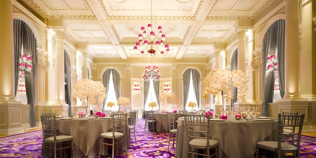 Elegant Ballroom in Corinthia London with floral centerpieces, perfect for weddings and events.