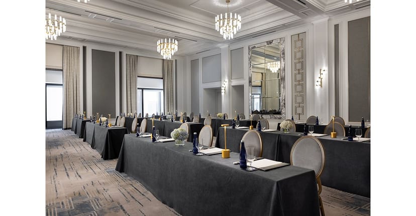Sophisticated meeting room at The Langham, Boston with elegant tables and warm lighting.