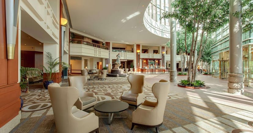 Spacious Hilton Boston Logan Airport event space with elegant seating and natural light.