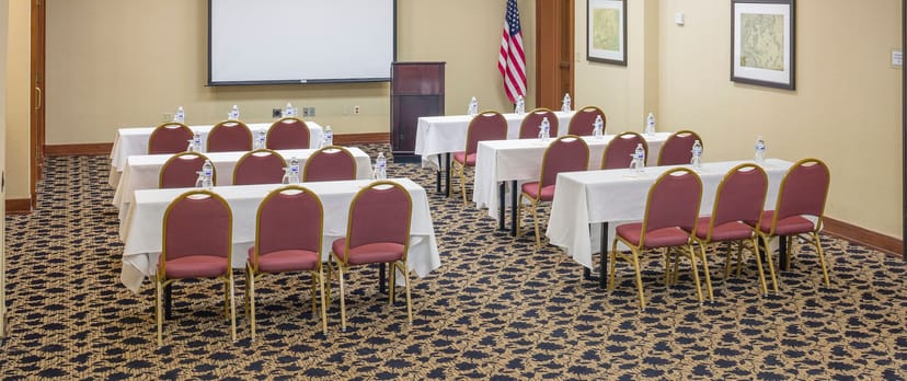 Conference Room at Hilton Boston Logan with tables, chairs for professional events.