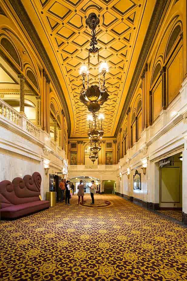 Lounge at Orpheum Theatre LA with elegant chandeliers, perfect for receptions and networking.
