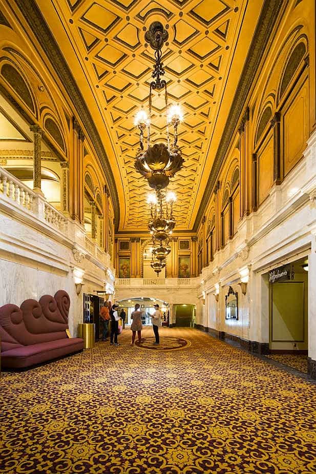 Lounge at Orpheum Theatre LA with elegant chandeliers, perfect for receptions and networking.
