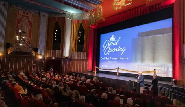 "Coolidge Corner Theatre grand opening with elegant audience and branded backdrop."