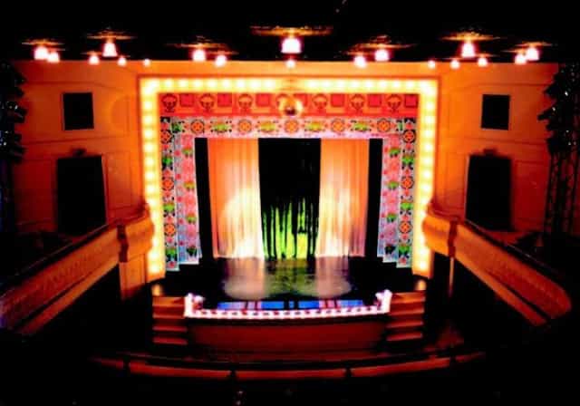 Larcom Theatre stage with floral backdrop, ideal for theatrical performances and corporate events.