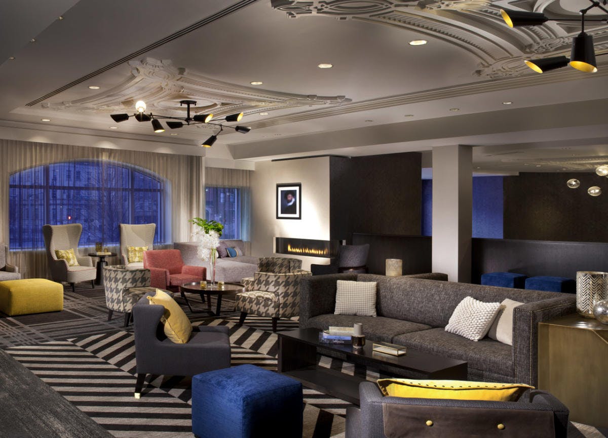 Olmsted Room at Hotel Commonwealth: modern lounge with elegant decor for networking events.