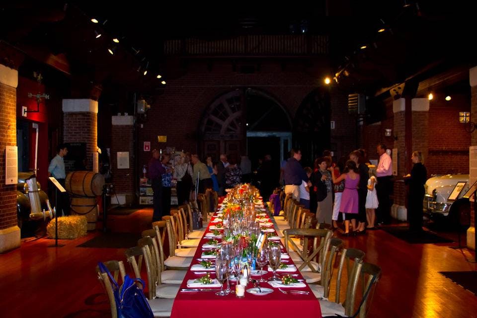 Elegant dining table in rustic Larz Anderson Auto Museum for events and gatherings.