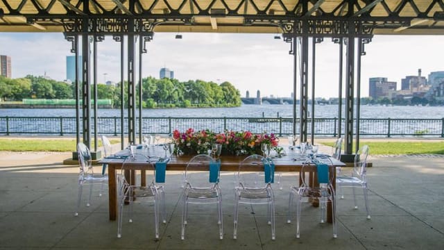 Elegant outdoor dining at Washburn Pavilion, featuring floral decor and waterfront views.