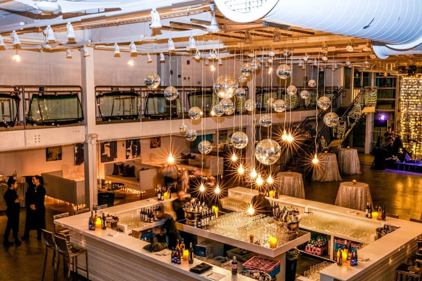 Art gallery event space with modern bar, colorful drinks, and elegant decor.