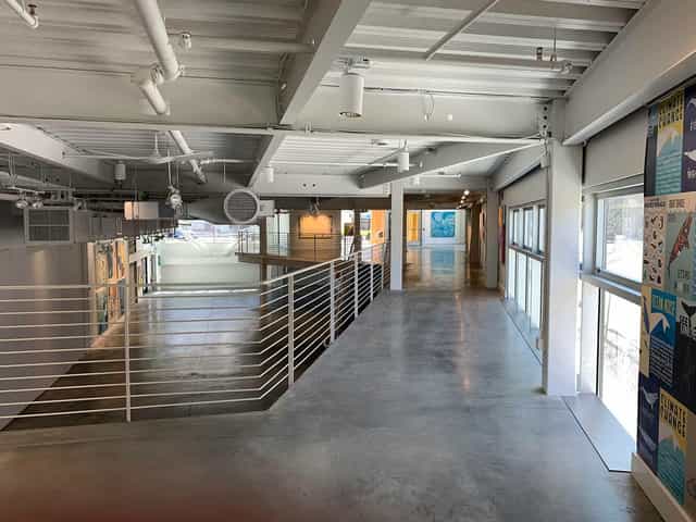 Modern art gallery with large windows, perfect for events and exhibitions.