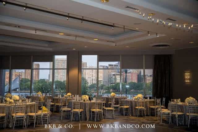Elegant ballroom with floral centerpieces, ideal for weddings and corporate events.