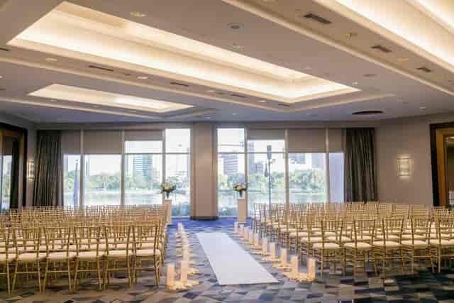 Outdoor wedding ceremony space with chiavari chairs and floral arrangements at Royal Sonesta Boston.
