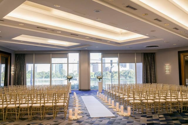 Outdoor wedding ceremony space with chiavari chairs and floral arrangements at Royal Sonesta Boston.