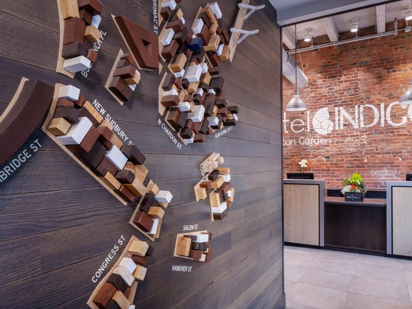 Stylish Hotel Indigo Boston Garden lobby with modern map, perfect for networking events.