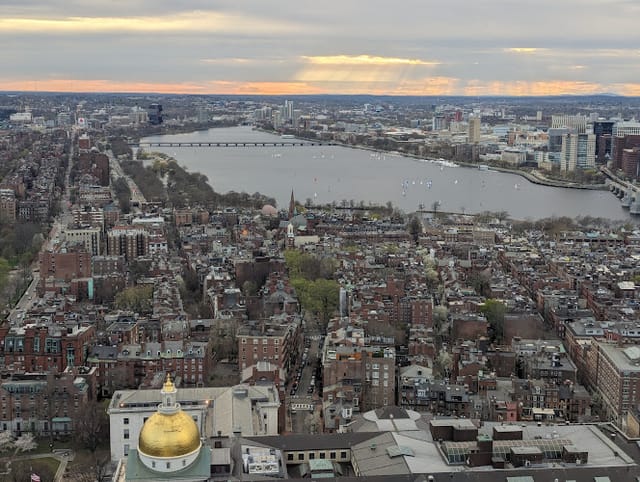 Aerial view of UMass Club dining room with skyline, ideal for conferences and events.