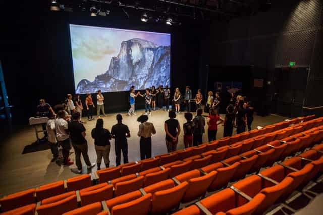 Barbara Lee Family Foundation Theater with orange chairs for interactive team-building event.