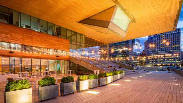 Modern outdoor event space at ICA Boston with greenery and string lights for gatherings.