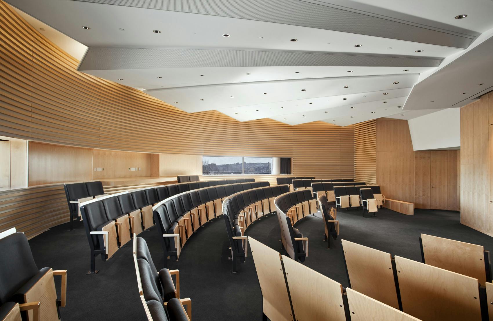Silverman Skyline Room at MIT Media Lab, modern auditorium with curved seating for workshops.