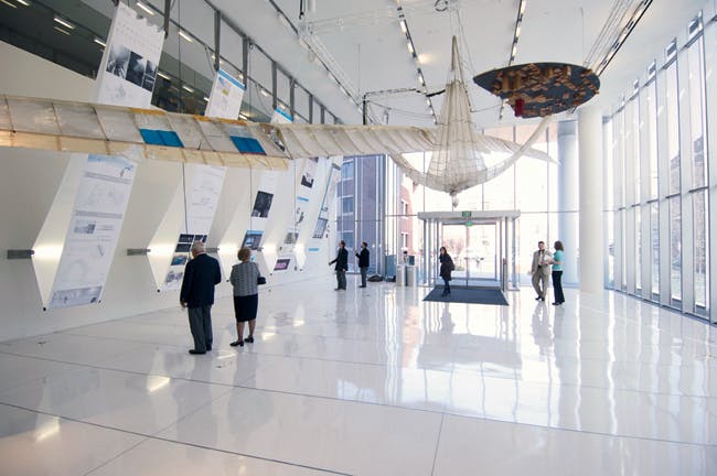 Modern MIT Media Lab lobby with high ceilings, ideal for networking events and conferences.