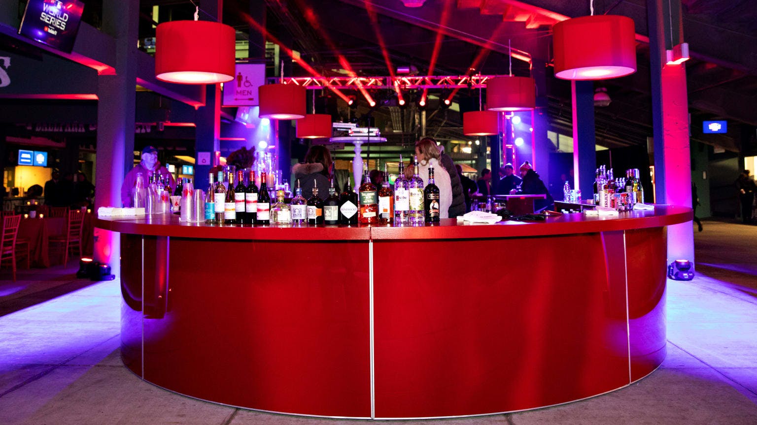 Vibrant Big Concourse at Fenway Park with sleek bar, ideal for networking events.