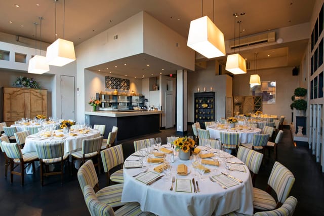 Elegant private dining room with round tables, ideal for corporate dinners and events.