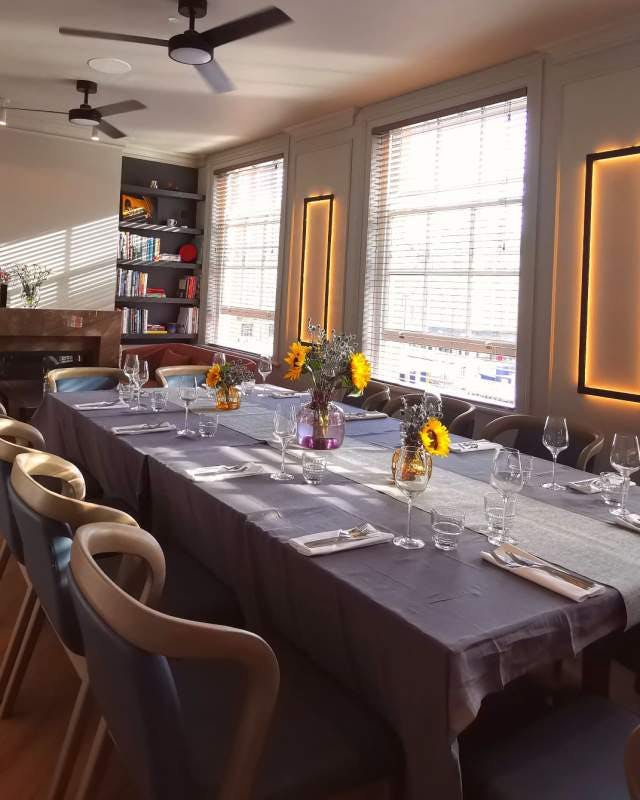 Private dining room with sunflower centerpieces for corporate meetings and special events.