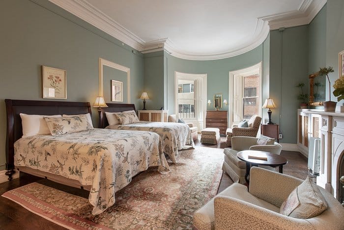 Event space at The College Club of Boston with two beds, ideal for gatherings and meetings.