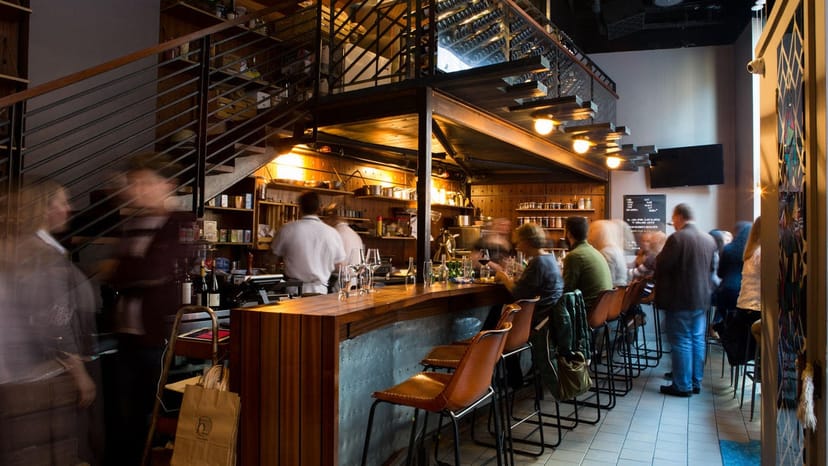 Vibrant Boston winery bar with warm lighting, ideal for networking events and gatherings.