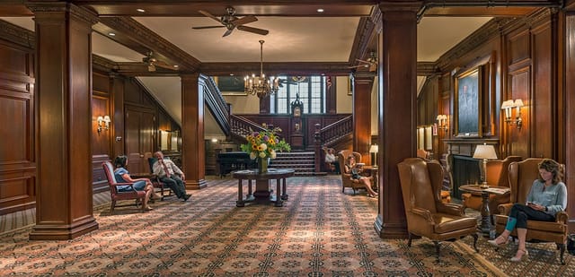 Elegant Harvard Club lobby with grand staircase, ideal for meetings and events.