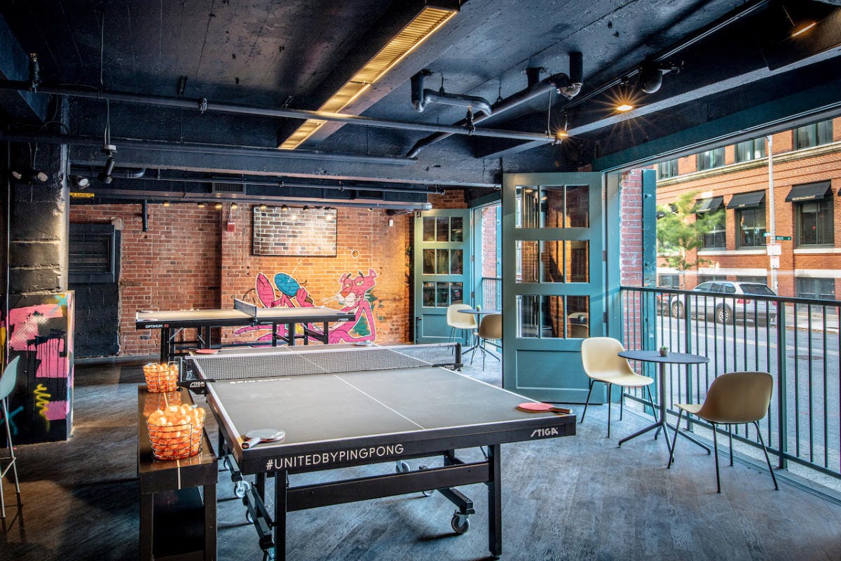 Vibrant SPIN Boston private lounge with ping pong tables for networking events.