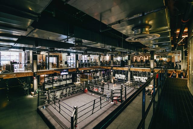Open Gym at EverybodyFights: modern fitness facility with boxing ring for corporate wellness events.
