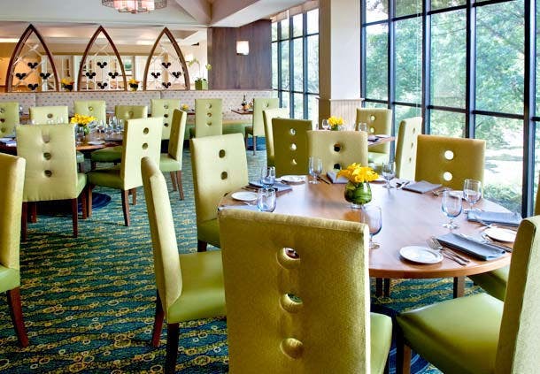 Riverside Lawn dining area with modern green chairs, perfect for corporate events and meetings.