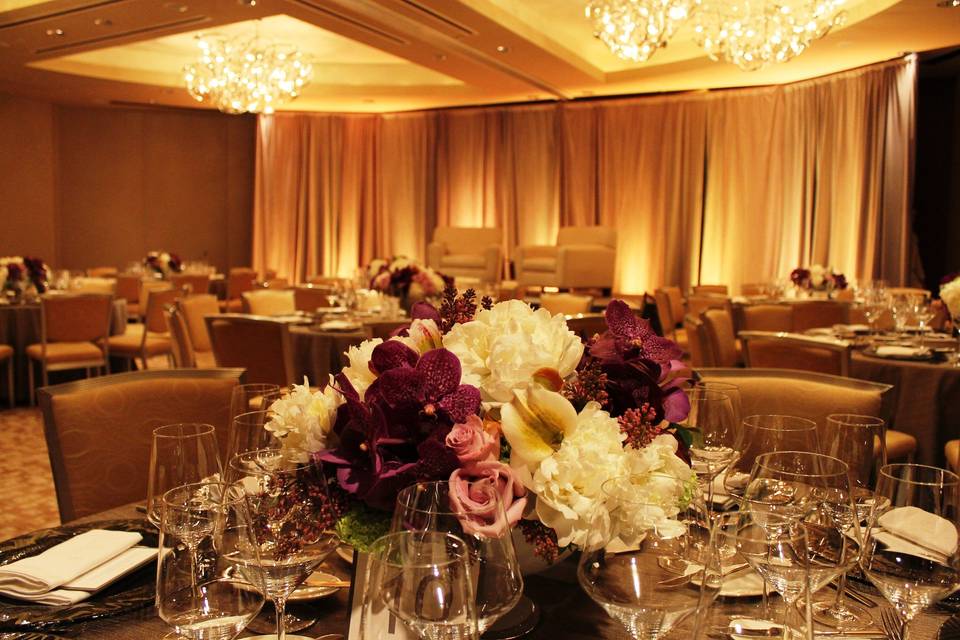 Elegant Harborview Ballroom with floral centerpiece, perfect for upscale corporate events.