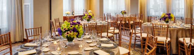 Elegant Harborview Ballroom with floral centerpieces, perfect for weddings and corporate events.